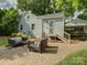 Charming backyard with a brick patio, seating area, and lush landscaping for outdoor relaxation at 1069 Sedgefield Rd, Charlotte, NC 28209