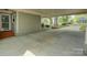 Large carport providing covered parking with access to the home's entrance and outdoor area at 1069 Sedgefield Rd, Charlotte, NC 28209