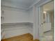 Walk-in closet with custom shelving system and access to the bathroom at 1069 Sedgefield Rd, Charlotte, NC 28209