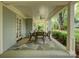 Spacious covered patio with a ceiling fan, comfortable seating, and a stone floor, perfect for relaxing outdoors at 1069 Sedgefield Rd, Charlotte, NC 28209