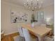 Bright dining room features a modern chandelier, seating for six, and decorative art at 1069 Sedgefield Rd, Charlotte, NC 28209