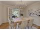 Bright dining room with chandelier, table seating, and french doors to patio at 1069 Sedgefield Rd, Charlotte, NC 28209