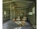 Inside of garage featuring a seating area with armchairs, shelves, and neutral decor at 1069 Sedgefield Rd, Charlotte, NC 28209
