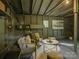 Garage interior featuring sitting area with artwork, plants, and neutral decor at 1069 Sedgefield Rd, Charlotte, NC 28209
