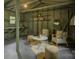 View of interior of garage with seating area, shelves, and desk with stool at 1069 Sedgefield Rd, Charlotte, NC 28209