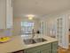 Kitchen island with a sink and view of breakfast nook with an open concept at 1069 Sedgefield Rd, Charlotte, NC 28209
