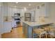 Well-lit kitchen featuring modern appliances and a kitchen island with seating at 1069 Sedgefield Rd, Charlotte, NC 28209