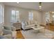 Inviting living room featuring a comfortable sofa, fireplace, and hardwood floors, filled with natural light from shuttered windows at 1069 Sedgefield Rd, Charlotte, NC 28209
