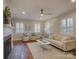 Elegant living room with a cozy fireplace, neutral decor, and shuttered windows, offering a comfortable and stylish space at 1069 Sedgefield Rd, Charlotte, NC 28209
