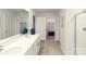 Bathroom featuring double sinks, a glass-enclosed shower, and entryways to separate walk-in closets at 123 Rustling Waters Dr, Mooresville, NC 28117