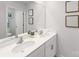 Bright bathroom featuring a double sink vanity, a large mirror, and modern fixtures and accents at 123 Rustling Waters Dr, Mooresville, NC 28117