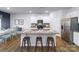 Bright kitchen features granite counters, stainless steel appliances, and seating at the island at 123 Rustling Waters Dr, Mooresville, NC 28117