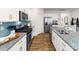 Modern kitchen boasts stainless appliances, granite counters, and sleek subway tile backsplash at 123 Rustling Waters Dr, Mooresville, NC 28117