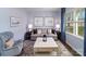 Cozy sitting room has a large window with hardwood floors and elegant decor at 123 Rustling Waters Dr, Mooresville, NC 28117