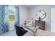 Stylish office featuring a glass-top desk, a comfortable chair, and a picturesque window view at 123 Rustling Waters Dr, Mooresville, NC 28117