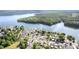 A wide angle aerial view captures homes and boat slips nestled along the water at 125 Maple St, New London, NC 28127