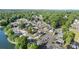 An aerial view captures the charming lakeside community surrounded by lush greenery and sparkling water at 125 Maple St, New London, NC 28127