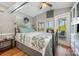 Comfortable bedroom with lake views from the screened porch, featuring a decorative quilt at 125 Maple St, New London, NC 28127