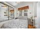 Cozy bedroom featuring a patterned bedspread, mirrored closet, and a ceiling fan at 125 Maple St, New London, NC 28127