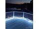 A waterfront deck with white railings and deck lighting offers a peaceful place to relax outdoors at 125 Maple St, New London, NC 28127