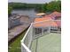 Scenic view of lakeside property with a green deck and access to the water at 125 Maple St, New London, NC 28127