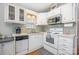 Well-lit kitchen with white cabinets, modern appliances, and tile backsplash, offering a functional and stylish cooking space at 125 Maple St, New London, NC 28127