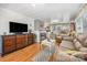 Cozy living room with wood floors, fireplace, comfortable seating, and natural light, perfect for relaxing at 125 Maple St, New London, NC 28127