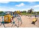 Community playground with a variety of colorful play equipment on a soft sandy surface at 125 Maple St, New London, NC 28127