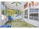 Inviting screened porch with comfortable seating and a green ceiling fan at 125 Maple St, New London, NC 28127