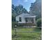 Quaint one-story home with covered porch and mature trees at 126 N Kendall St, Norwood, NC 28128