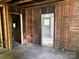 Unfinished living room featuring exposed wood framing and flooring at 126 N Kendall St, Norwood, NC 28128