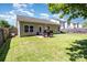View of the well-manicured backyard featuring a patio area, green lawn, and privacy fence at 12792 Clydesdale Dr, Midland, NC 28107