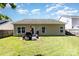 View of the home's backyard with a well-maintained lawn, grill, patio and privacy fence at 12792 Clydesdale Dr, Midland, NC 28107