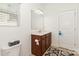 Bright bathroom with a dark wood vanity, a toilet and a patterned bath mat at 12792 Clydesdale Dr, Midland, NC 28107