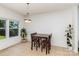 Cozy dining area with wood table, pendant lighting, tiled floors and backyard views at 12792 Clydesdale Dr, Midland, NC 28107