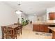 A dining area features a table with seating, opening to a living area and modern kitchen at 12792 Clydesdale Dr, Midland, NC 28107
