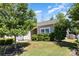 Well-kept home featuring a lush green lawn, mature trees, manicured shrubs and vinyl siding at 12792 Clydesdale Dr, Midland, NC 28107