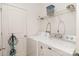 Bright laundry room with washer, dryer, shelving, and utility closet at 12792 Clydesdale Dr, Midland, NC 28107