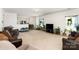 Spacious living room with neutral carpet, ample natural light, and an open layout flowing into the dining area at 12792 Clydesdale Dr, Midland, NC 28107