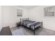 Simple bedroom with metal bed frame, gray vinyl flooring, and natural light at 128 Paul Snipes Rd, Lancaster, SC 29720