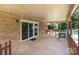 View of covered patio with table and chairs extending from brick home at 128 Paul Snipes Rd, Lancaster, SC 29720