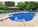 Backyard pool with diving board, lounge chairs, a covered porch and a green fence at 128 Paul Snipes Rd, Lancaster, SC 29720