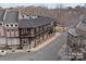 A charming brick building with a black metal roof and inviting outdoor seating on the second-story balcony at 13838 Winmau Ln, Huntersville, NC 28078