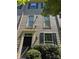 Two-story home featuring balcony access and dark shutters, bathed in natural light at 13838 Winmau Ln, Huntersville, NC 28078