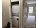 Convenient laundry closet featuring a stacked washer and dryer unit, optimizing space at 13838 Winmau Ln, Huntersville, NC 28078