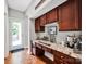 This bar area features granite countertops, wood cabinets, and a beverage center at 14940 Carbert Ln, Huntersville, NC 28078