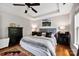This main bedroom offers neutral decor, tray ceilings and hardwood floors at 14940 Carbert Ln, Huntersville, NC 28078