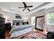 Inviting bedroom with tray ceiling, large mirror, and stylish decor at 14940 Carbert Ln, Huntersville, NC 28078