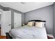 Cozy bedroom with gray walls, comfortable bed, and natural light from the windows at 14940 Carbert Ln, Huntersville, NC 28078