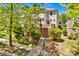 Charming two-story home with brick accents, lush landscaping, and a inviting front porch at 14940 Carbert Ln, Huntersville, NC 28078